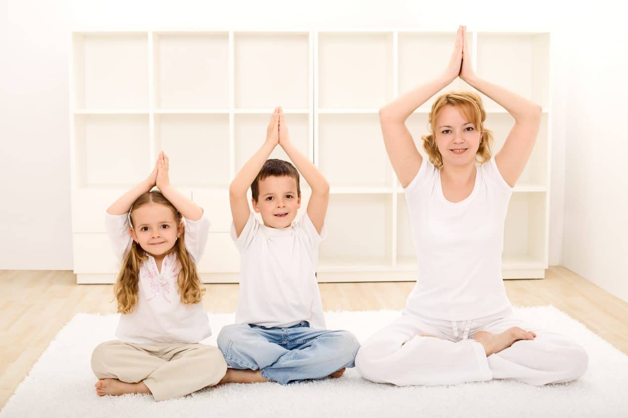 Portrait of 5-6 years old little child girl in downward facing dog pose,  looking at camera while practicing yoga at home 22971358 Stock Photo at  Vecteezy